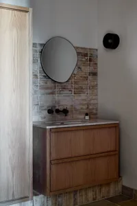 A modern floating bathroom vanity with a wooden finish.
