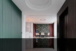 A modern interior design featuring a black and white color scheme with mid-century modern furniture and geometric patterns.