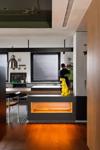 Modern kitchen with concrete countertop and lighting fixture