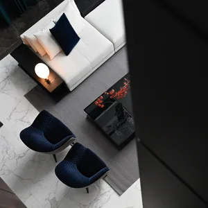Modern living room featuring a marble floor and velvet furniture.