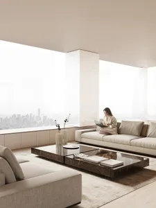 A modern living room with marble furniture and cityscape view.
