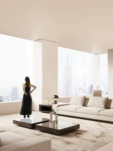 Contemporary, minimalist living room with white furniture, large windows, and city view.