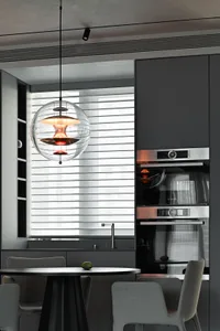 A minimalist kitchen featuring modern metal and glass elements.