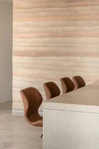 Minimalist interior design featuring concrete and leather furniture.