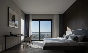 Modern, minimalist bedroom featuring a sofa and marble surface.
