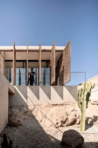 A modern building featuring a binary structure with concrete and glass materials.