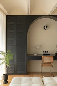 A modern home office space featuring black, gray, and dark wooden elements with a minimalist design.