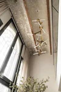 A modern interior space featuring a concrete ceiling with industrial design elements.