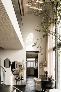Modern living room with mixed-media decor and a high ceiling.