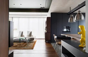 Minimalist living room with clean lines, white walls, and a wooden floor.