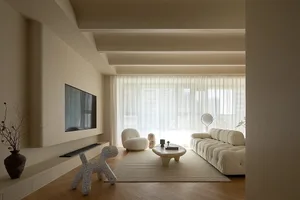 A modern living room with neutral-toned furniture and decor.