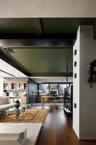 Living, dining, and kitchen areas in a modern open-concept interior design with mixed materials.
