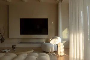 A modern minimalist living room with neutral colors and a large television mounted on the wall.