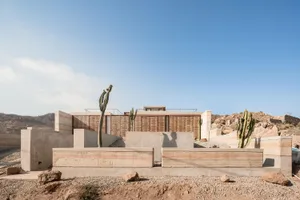 A minimalist building with concrete and wooden finishes.