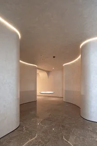 A minimalist interior space with concrete walls and floor.