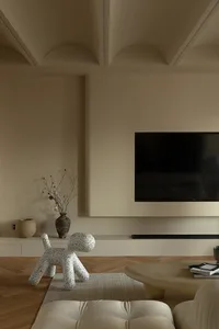 A minimalist residential interior with a concrete floor, wooden furniture, and a floor-to-ceiling window.