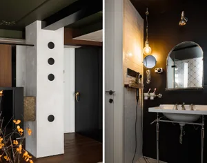 A modern bathroom with white brick tiles and concrete features, including a white sink, mirror, and hanging lamps.