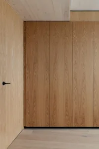 Modern interior with wooden cabinets and light-colored flooring.