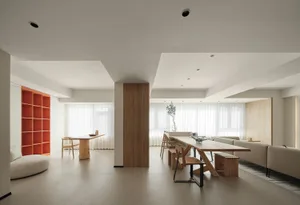 A modern living room featuring a wooden table and chairs under a white ceiling.
