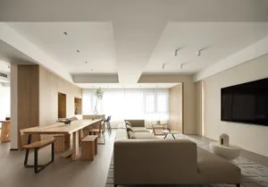 Modern living room with a minimalist design, featuring a large sectional sofa, a minimalistic coffee table, and a sleek, uncl