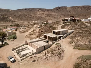 Modern residential architecture featuring contemporary design in a desert setting.