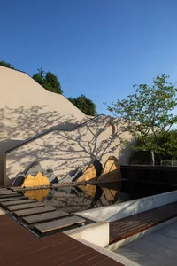 A visually striking water feature with natural stone elements and a minimalist design, surrounded by a serene and structured