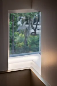 A close-up of a modern window with glass and a minimalist interior design.