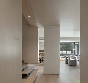 An image depicting a modern minimalist residential interior with a focus on wood elements.