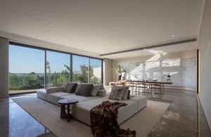 Modern living room featuring neutral-colored fabrics and minimalist design.