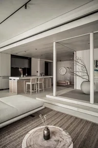 A modern interior living room with minimalist design and wooden materials, featuring a sofa, coffee table, and decorative vas