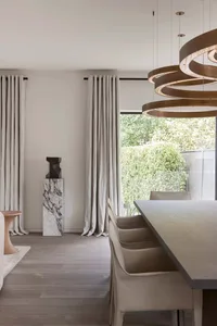 Modern, minimalist residential interior featuring clean lines, neutral tones, and a large window.