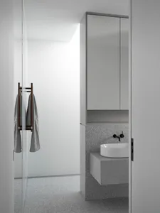 Modern bathroom interior featuring a concrete sink and walls.