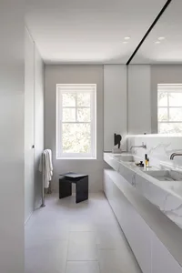 Modern bathroom featuring marble countertop and concrete floor