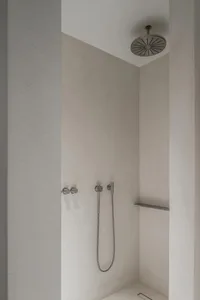 A modern concrete bathroom with minimalist design elements and clean lines.
