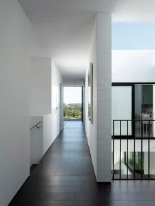 View of a modern interior design featuring white walls, hardwood floors, and a minimalist aesthetic.