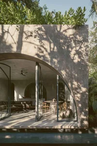 Modern living space with concrete walls and large windows.