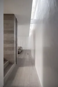 Modern minimalist residential interior design featuring wood flooring and minimalist architecture.