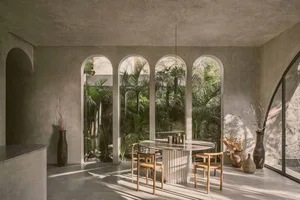 Modern restaurant interior with minimalist design, featuring concrete walls, arched windows, and a glass dining table surroun