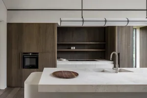 Modern interior kitchen featuring a concrete countertop and minimalist design.