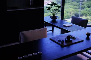 A minimalist office space featuring wooden furniture and a potted plant.
