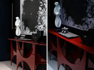 Modern console table featuring black and white contrast, with sculptures and vases adorned on its surface.