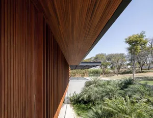 Modern house exterior with wooden cladding and glass windows