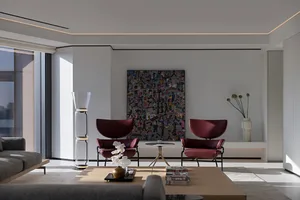 Contemporary living room featuring modern furniture with marble, glass, and upholstered elements.