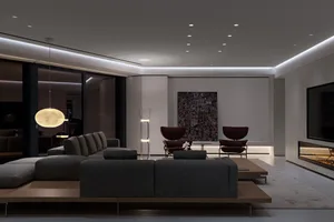 Modern living room featuring metallic accents, glass elements, and fabric seating.