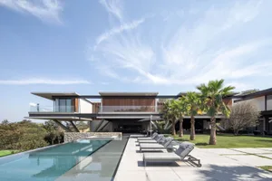 Modern residential house with concrete and glass exterior.