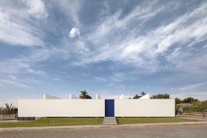 A sleek, modern building facade rendered in pure white, evoking a sense of minimalism and contemporary architecture.