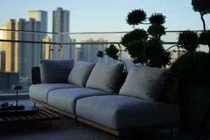 Modern living room with minimalist decor and cityscape view.