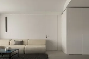 A minimalist living room with neutral finishes and a modern sofa.