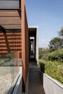 Modern architectural design featuring glass walls and concrete elements.