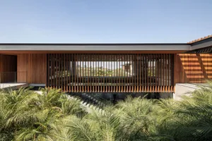 A modern architectural exterior featuring a wooden facade with vertical slats.